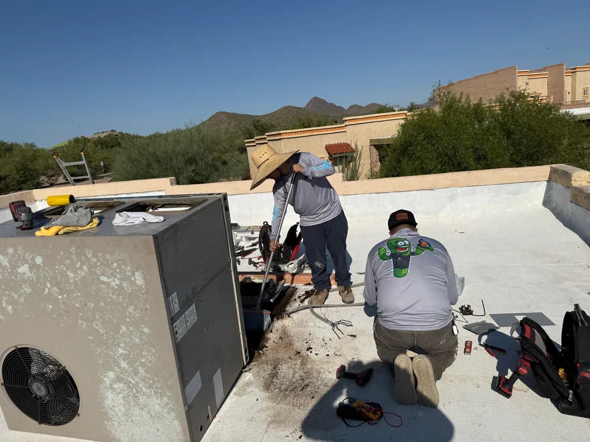 ABC Water & Air technicians repairing a rooftop AC unit